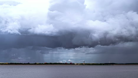 Time-lapse-of-storm-clouds-gathering-over-town,-dumping-sheets-of-rain