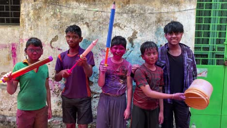 Group-of-Kids-with-colors-applied-dancing-during-Holi-festival-celebration