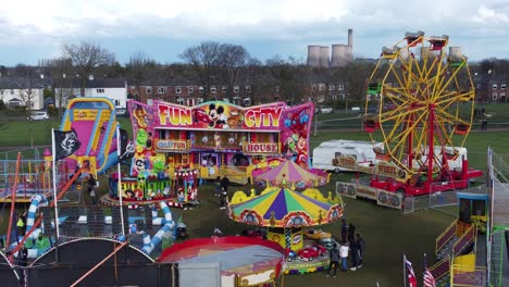 Small-town-fairground-Easter-holidays-funfair-carousel-rides-in-public-park-aerial-view