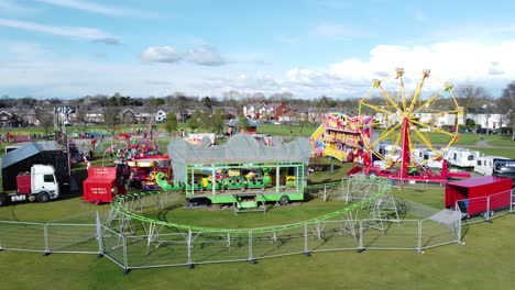 Small-town-fairground-Easter-holidays-funfair-rides-in-public-park-aerial-view-of-caterpillar-ride