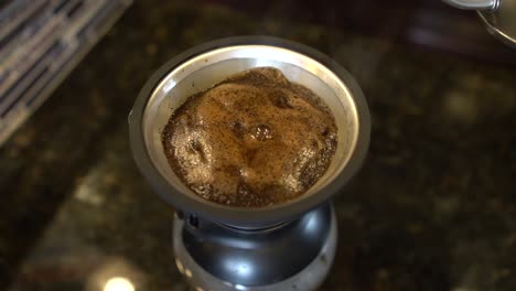 Close-up-top-view-of-pouring-hot-water-in-coffee-maker-for-making-coffee