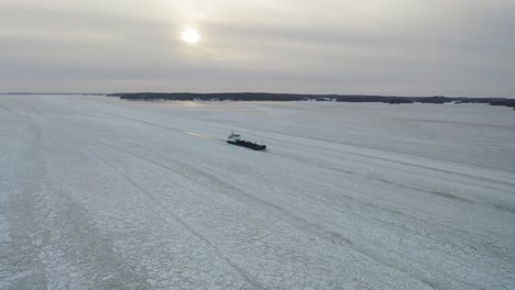 Aerial-view-of-oil-and-chemical-tanker-CRYSTALWATER-call-sign-ESLI-moving-ahead-in-ice-covered-Finnish-archipelago