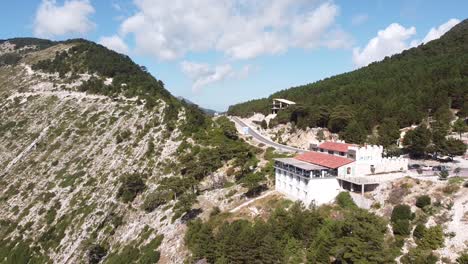 Llogara-Pass,-Albania---Aerial-of-Restaurant-and-Road-at-Highest-Point-of-Mountain-Pass