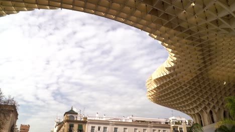 Tilt-down-from-famous-Metropol-Parasol-in-Seville,-Andalusia,-Spain