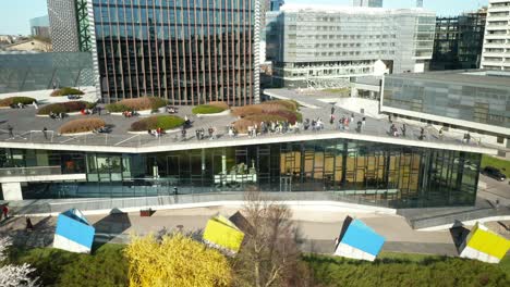 AERIAL:-People-Walking-on-Swedbank-Terrace-in-Vilnius-During-Cherry-Blossom-Season-on-Sunny-Evening