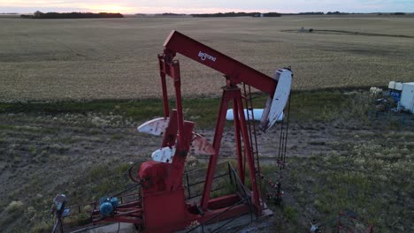Red-leGrand-oil-pumping-working-consistently-during-a-vibrant-sunset-in-the-prairies