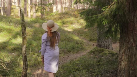 Single-girl-walks-away-wandering-through-woods-forest-path,-summer-activity