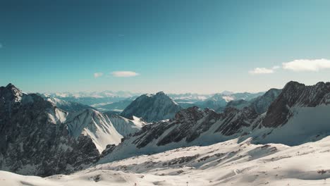 Drone-shot-of-Alpine-mountains-of-Germany---Zugspitze,-Garmisch-Partenkirchen,-ski-slopes-in-the-background