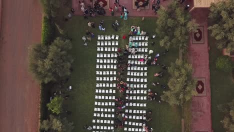 Drone-top-view-of-the-wedding-venue-in-a-green-field-under-the-tree