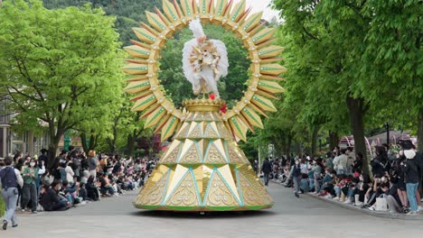 The-crowd-is-excited-by-a-dancing-character-atop-a-golden-parade-float-at-Everland-Amusement-Park-in-Korea