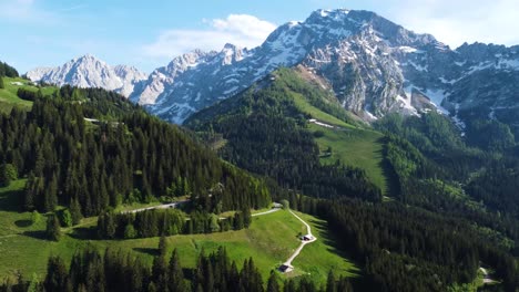Aerial-Drone-Shot-of-Snow-Peak-Alps-Mountain,-Green-Valley,-and-Pine-Trees---Bavaria,-Germany