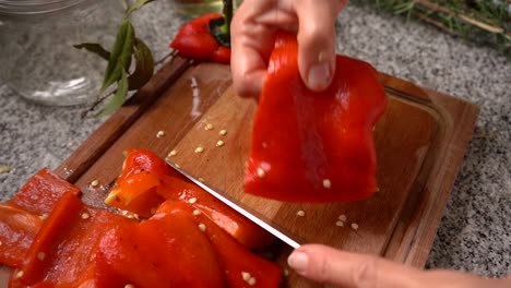 Cutting-Roasted-Red-Bell-Pepper-On-Chopping-Board