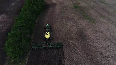 Eine-Aufnahme-Aus-Der-Vogelperspektive,-Die-Einem-John-Deere-Traktor-Folgt,-Der-Ein-Feld-Sät