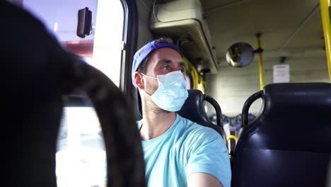 Young-male-backpackers-enjoying-travelling-around-Costa-Rica-in-local-bus-transportation-wearing-protective-mask-against-virus-pandemic-following-rule-and-regulations