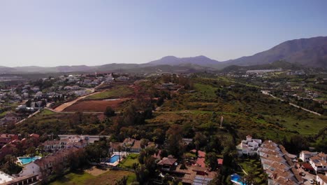 Aerial-Over-Holiday-Villas-With-Mountain-In-Background-In-Estepona,-Costa-del-Sol