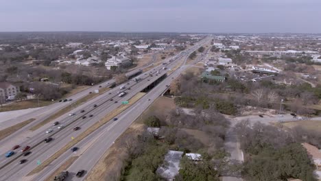 Aerial-view-of-Interstate-35-near-downtown-Round-Rock,-Texas-on-a-sunny-day