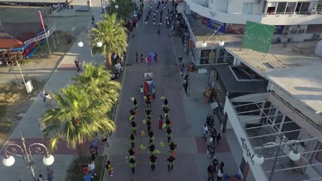 Overtake-Shot-Of-Crowded-street-With-People-Celebrating-Larnaca-Yearly-Parade