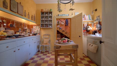Checkered-floor-kitchen-with-rustic-decoration-and-food-items,-Dolly-out-shot