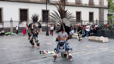 frontal-slow-motion-shot-of-aztec-rain-dance-in-front-of-national-palace