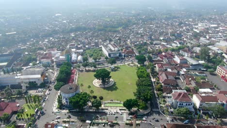 Morning-traffic-in-city-square-in-Magelang,-Indonesia,-aerial-panorama