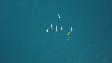 Aerial-Top-Down-Shot-Of-Group-Of-Lost-Kayaks-In-Blue-Ocean