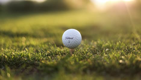 Titleist-Golfball,-Der-Von-Einem-Schwingenden-Eisenschläger-Auf-Der-Driving-Range-Des-Golfplatzes-Getroffen-Wird