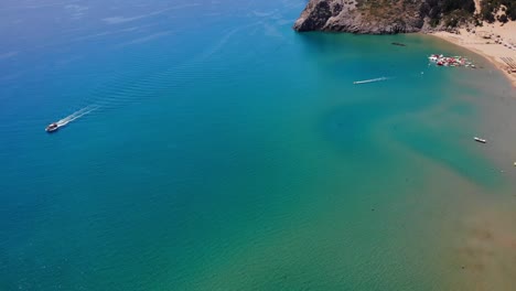 Boat-Cruise-At-Tsambika-Beach,-Rhodes,-Greece---aerial-drone-shot