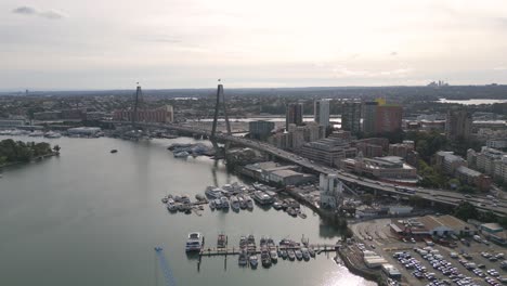 Aerial-view-of-Anzac-Bridge-and-car-traffic-over-the-marina-at-Sydney-Harbour-on-sunset