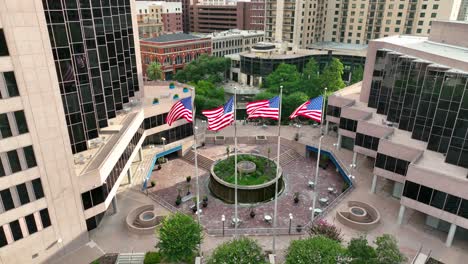 IBC-Bank-with-four-American-USA-flags,-downtown-San-Antonio-skyline-and-skyscrapers