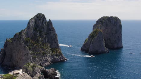 Picturesque-Sea-Stack-Faraglioni-Rocks-on-Coast-of-Capri-Island,-Italy---Aerial