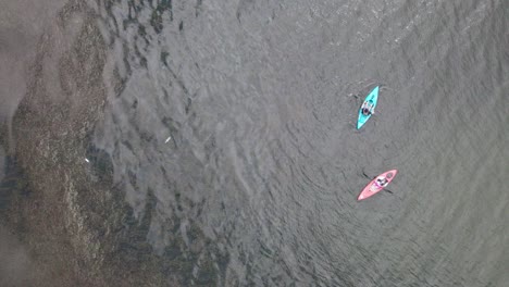 Aerial-bird's-eye-view-over-tourists-kayaking-in-the-lake-at-daytime