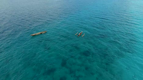 Nungwi-Beach,-Zanzibar---Tanzania---June-18,-2022---Boats-on-the-Indian-ocean-on-a-sunny-cloudy-day-during-sunrise