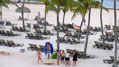 Tilt-up-shot-of-large-family-on-Caribbean-beach