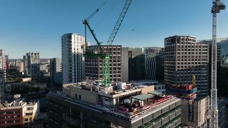 Aerial-Drone-Helicopter-view-of-the-cranes-to-build-new-skyscrapers-in-the-City-of-London-with-city-of-London-in-background