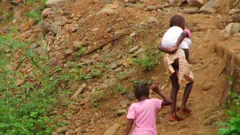 Young-African-siblings-walk-up-a-hill