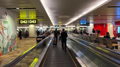 Singapore-airport-transit-hub-with-passengers-from-all-over-the-world-waiting-and-transiting-at-Singapore-Changi-airport,-southeast-Asia,-point-of-view-shot