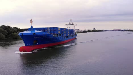 Aerial-Parallax-Around-Forward-Bow-Of-Tailwind-Panda-Container-Ship-Along-Oude-Maas-Passing-Another-Ship