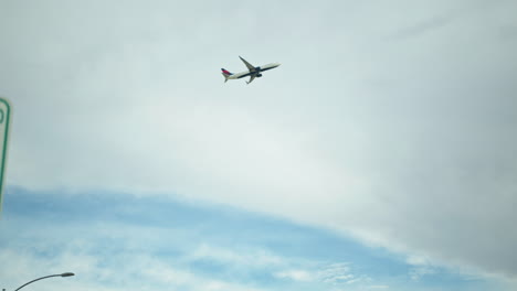 Slow-Motion-Wide-Pan-Right-of-a-Delta-Air-Lines-Plane-Taking-Flight