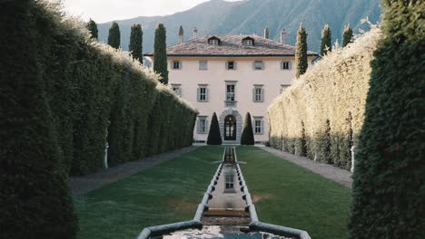 Walking-through-the-front-garden-entrance-of-famous-Villa-Balbiano-at-lake-como-italy-wedding-venue-location---cinematic-slowmotion