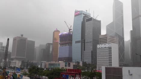 Corporate-skyscraper-buildings-in-Central,-Hong-Kong-during-a-rainstorm