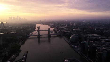 London-UK,-Cinematic-Aerial-View-of-Sunset-Above-Cityspace-Skyline,-Tower-Bridge-and-Buildings-Silhouettes,-Drone-Shot