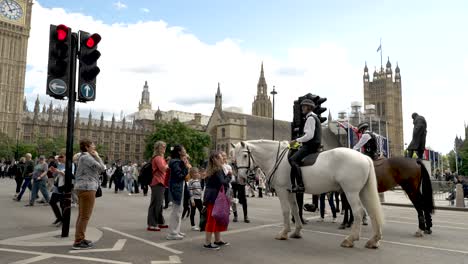 Met-Police-Mounted-On-Horseback-Greeting-Tourists-On-Closed-Parliament-Square-In-London