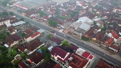 Aerial-top-down-shot-of-cars-on-road-in-neighborhood-in-central-java,-Indonesia
