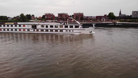 Aerial-Starboard-View-Beside-Olympia-Cruise-Ship-Passing-Another-Ship-On-River-Noord