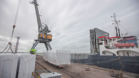 A-crane-on-the-dock-loading-shipping-containers-on-a-vessel---time-lapse