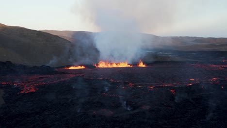 Wild-basalt-rock-filled-Meradalir-valley-with-lava-spewing-Fagradals-volcano