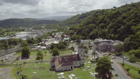 Pull-away-reveal-of-St-Mary-Parish-Church-in-Port-Maria,-Jamaica-to-show-the-town-from-above