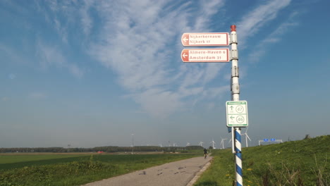 A-race-bicyclist-training-on-a-bicycle-path-in-the-Dutch-landscape