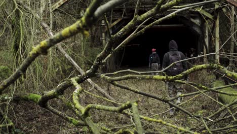 Two-young-men-entering-an-abandoned-tunnel