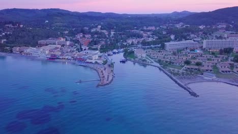 Greece,-Corfu-Island,-drone-footage-of-a-beautiful-sunset-over-Messonghi-Beach